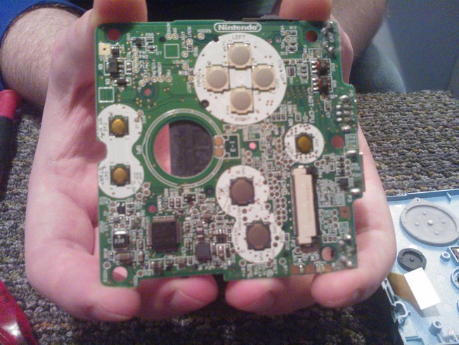 The under side of the main board showing the metal contacts for the
				buttons