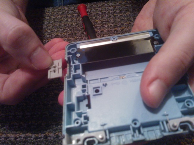 The power switch held next to the case showing where it fits