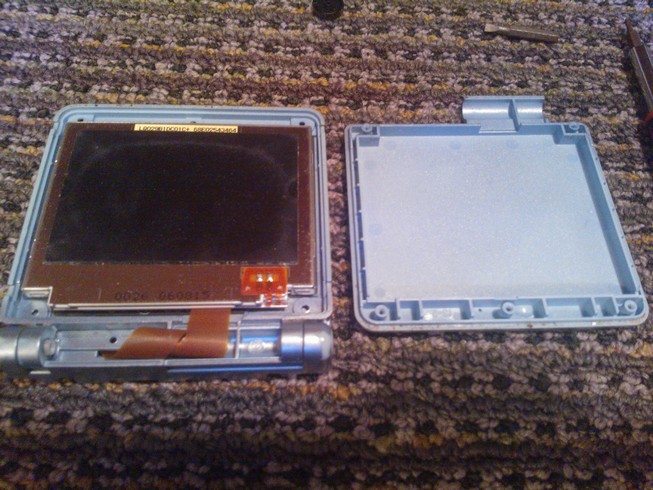 The back of the screen shown with the panel that was removed set next
				to it
