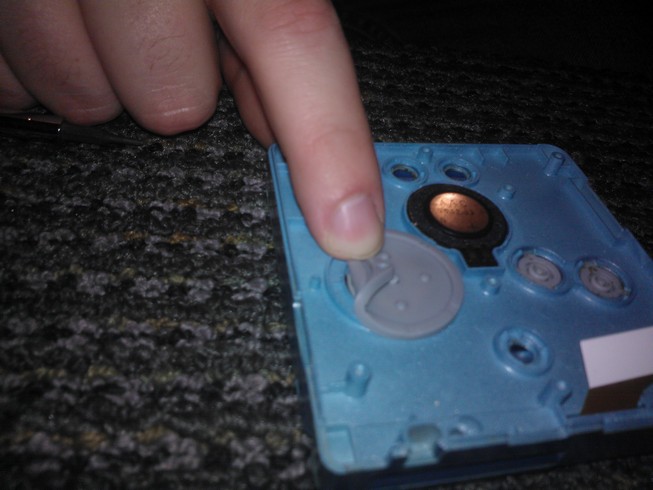 Attaching the hole in the silicon cover to the peg on the
				case